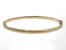 A 9ct yellow gold hollow bangle, internally 65 mm x 56 mm. CONDITION REPORT: 4.