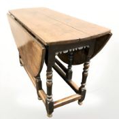 A George III oak gate leg dining table, overall 147 cm x 120 cm x 76 cm,