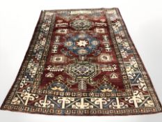 An Afghan carpet of Caucasian design, 257 cm x 201 cm.