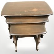 An Ercol stained elm nest of three tables, width 57 cm.