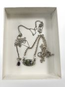 Three silver pendants on white metal chains