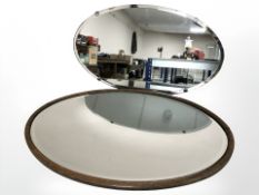An oak oval mirror and an Art Deco frameless mirror, largest 71 cm wide.