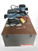 Two Makita electric sanders in enameled storage cases.