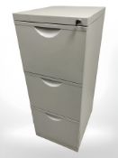 A metal three drawer filing cabinet with key,