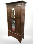 A late Victorian mahogany and satinwood mirror door wardrobe,