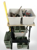 A folding work bench, several plastic trays and boxes containing hand tools, clamps, etc.