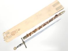 A replica Excalibur sword in leather sheath, length 109 cm.