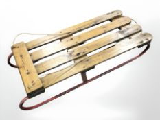 A vintage pine and metal sledge