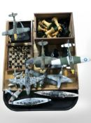 A group of miniature World War II battleships, fighter aircraft, boxwood chess set and board, etc.