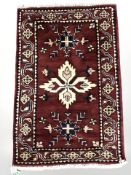 An Afghan rug of caucasian design, 101 cm x 66 cm.