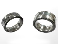 Two silver rings formed from a Canadian Dollar and Two Shilling coin.