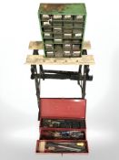 A folding work bench and two metal tool chests containing hard ware etc