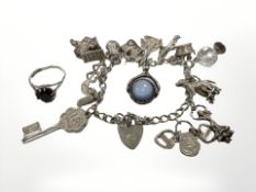A silver charm bracelet together with a dress ring CONDITION REPORT: Gross 52g