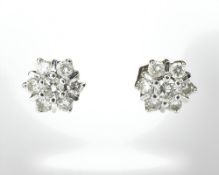 A pair of 18ct white gold seven stone diamond cluster earrings CONDITION REPORT: