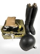A pair of riding boots with stretchers, a pair of steel capped boots and a riding helmet.