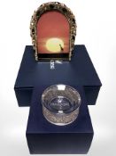 A Swarovski photograph frame, together with a crystal ornate candle stand, all boxed.