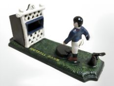 A cast iron football bank figure.