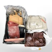 A crate of new stock items, bags and holdalls, leather bag, etc.