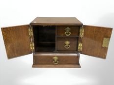An oak smoker's box, fitted with drawers.