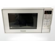 A Panasonic microwave oven, together with opoerating instructions.