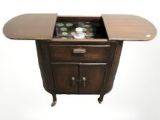 A mid 20th century drinks trolley with sliding top,