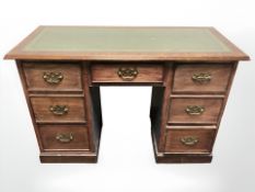 An early 20th century mahogany pedestal desk with green inset top,