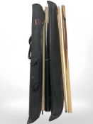 A three piece pool cue by BCE, together with a two piece cue,
