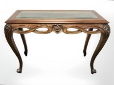 A reproduction mahogany glazed console table, width 110 cm.