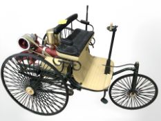 A miniature live steam model of an antique three wheeled tricycle, height 18 cm.