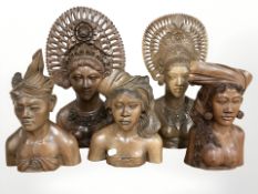 A group of carved Balinese figures, tallest 37 cm.