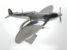An aluminium model of Spitfire on stand.