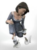 A Spanish Elisa figure depicting a lady holding a dove, together with two further doves, not boxed.