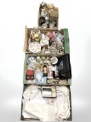 Four boxes containing lace, linen, tankards, a mantel clock, china figures and ornaments, etc.