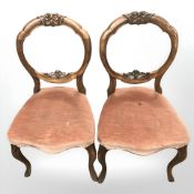 A pair of 19th century walnut balloon back chairs.