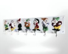 A cast iron seven dwarf coat rack.