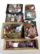 A pallet of Christmas decorations including baubles, approximately seventy packs of gift tags,