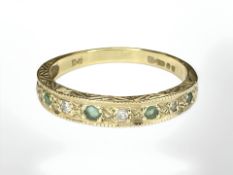An 18ct gold emerald and diamond half-eternity ring, size P. CONDITION REPORT: 2.