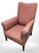 A late Victorian fireside armchair upholstered in burgandy fabric,