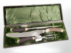 A William Gregory & Sons Sheffield steel three-piece carving set with simulated horn handles,