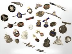 A collection of military badges including examples in silver.