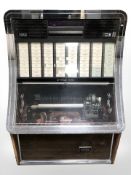 A vintage NSM Prestige ES160 juke box with a quantity of singles