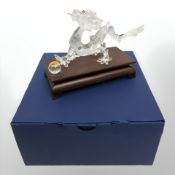 A Swarovski figure of a Chinese dragon with pearl, boxed.