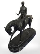 A 20th century bronze figure of a jockey on horseback, standing on black marble plinth, height 38.