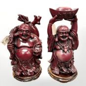 A Pair of ornate resin Bhudda figures, one holding a bowl over his head,