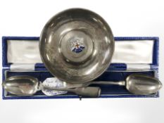 A small silver dish with enameled crest, together with two silver 19th century teaspoons.