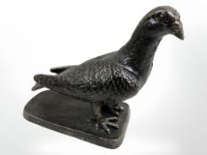 A cast iron figure of a pigeon.