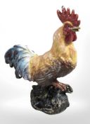 A cast iron painted figure of a cockerel.