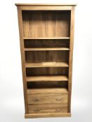 A light oak bookcase fitted with two drawers, width 90 cm, height 199 cm.