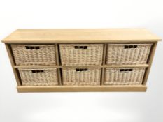 A contemporary light oak six drawer wicker chest,