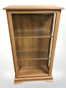 A reproduction mahogany effect glazed bookcase, width 67 cm.